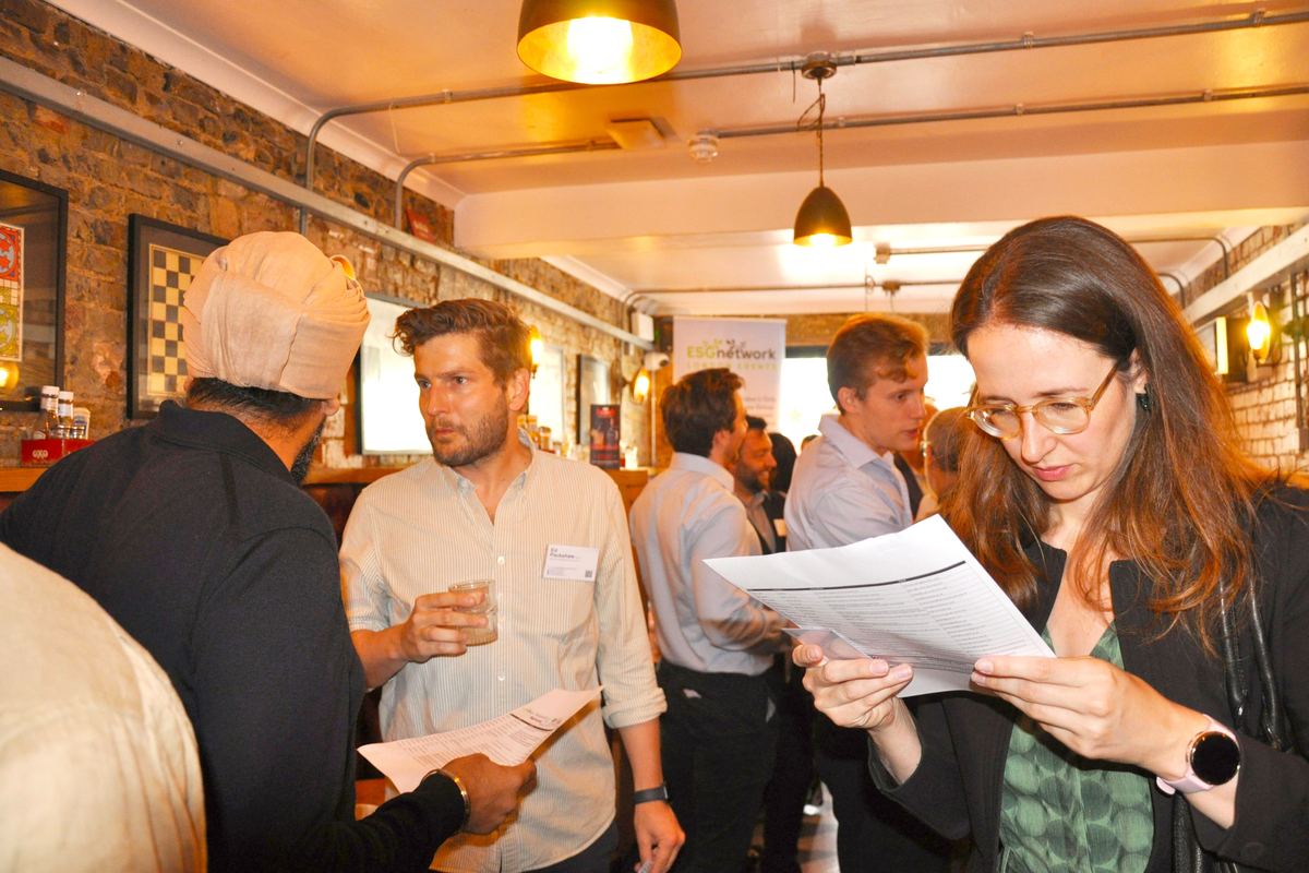 A guest checking the printed attendee list at a morning networking event